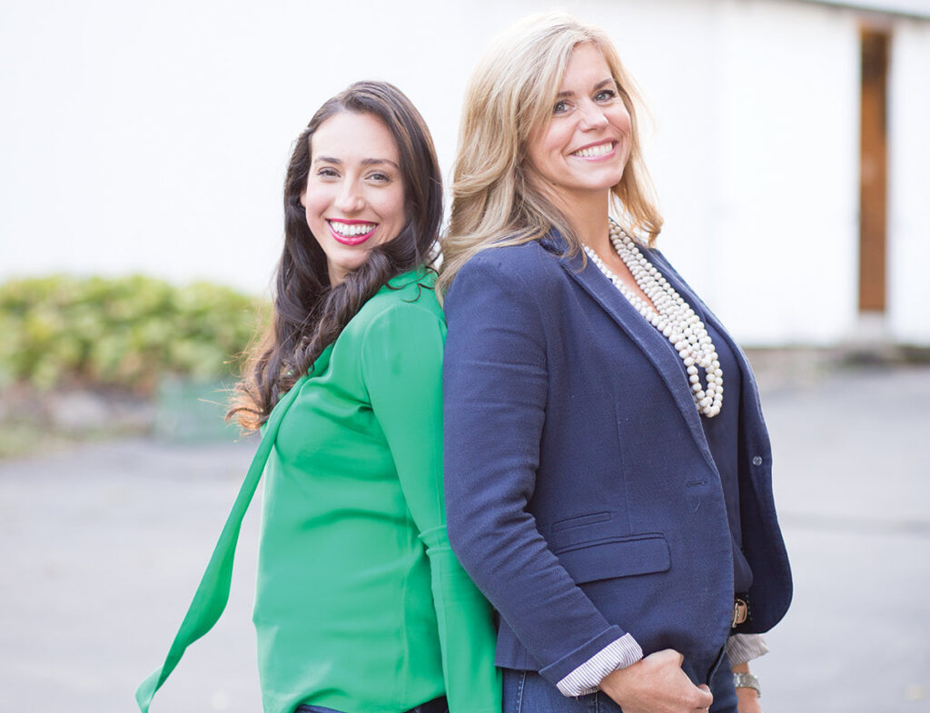 Two women pose outside for a branding session