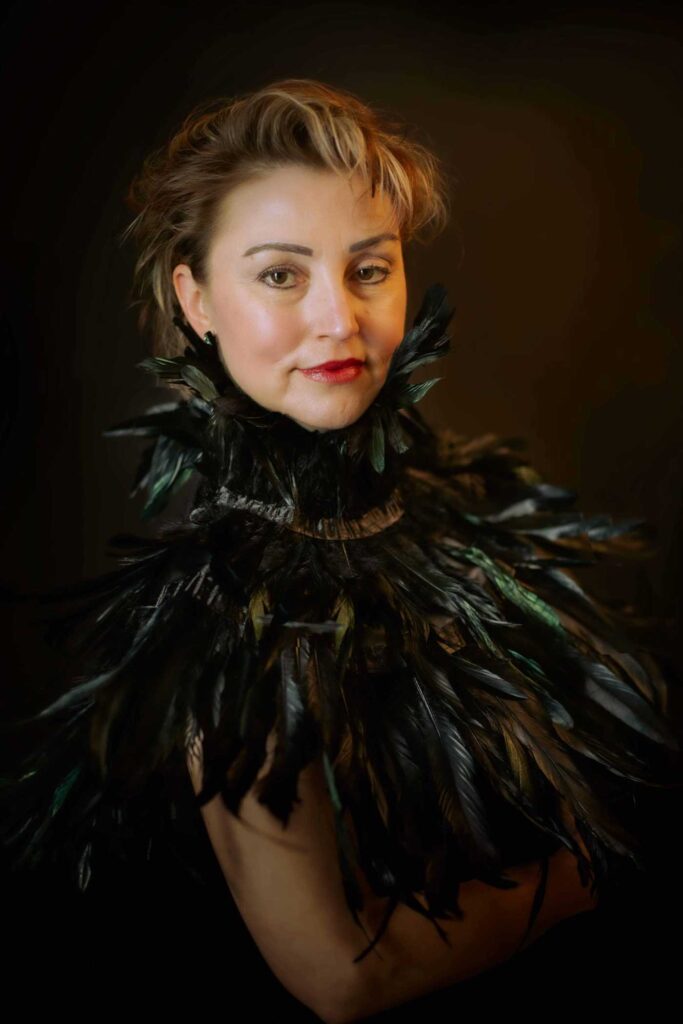 woman poses with feather collar